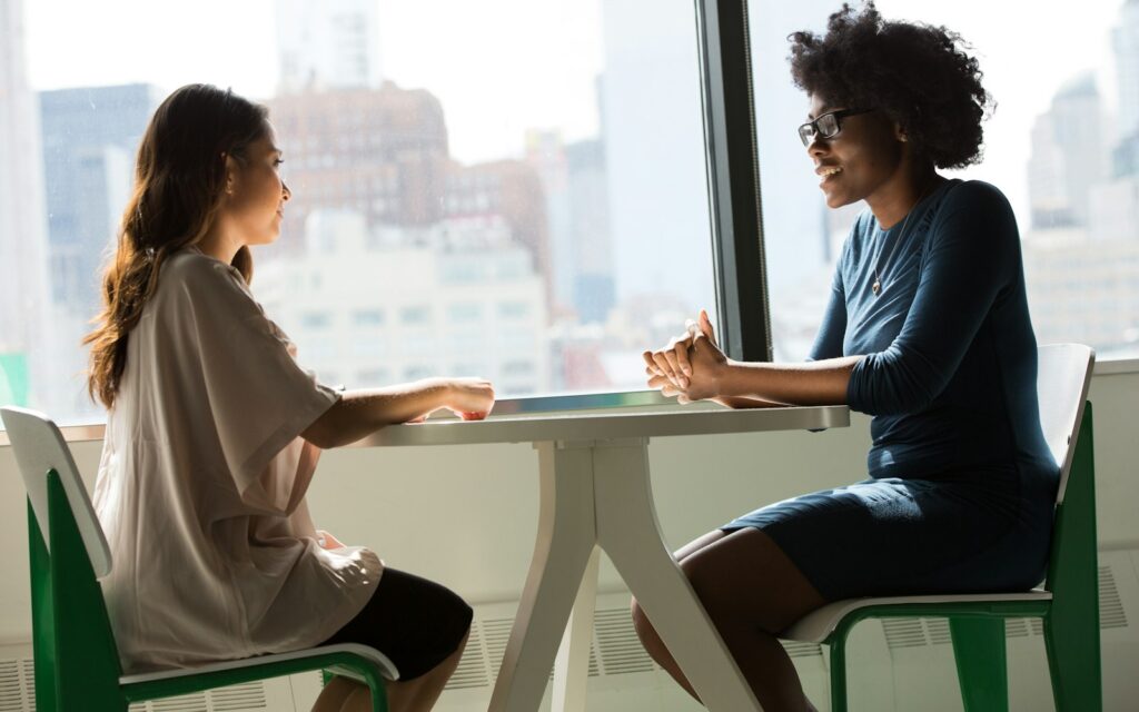 Vorstellungsgespräch für den ersten Marketing-Hire: Zwei Frauen im Gespräch am Tisch