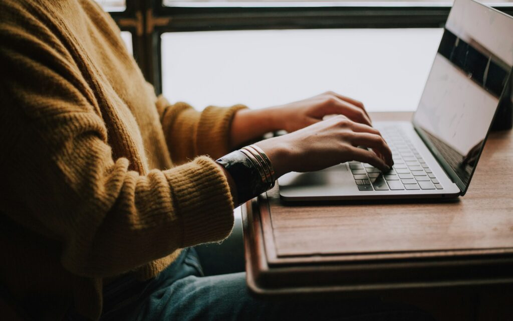 Person arbeitet am Laptop an Inhalten für Generative Engine Optimization