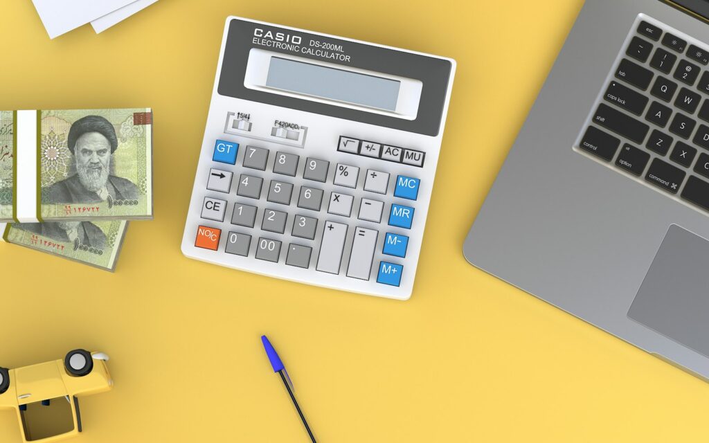 Taschenrechner am Schreibtisch als Sinnbild für die Kalkulation des Marketingbudgets